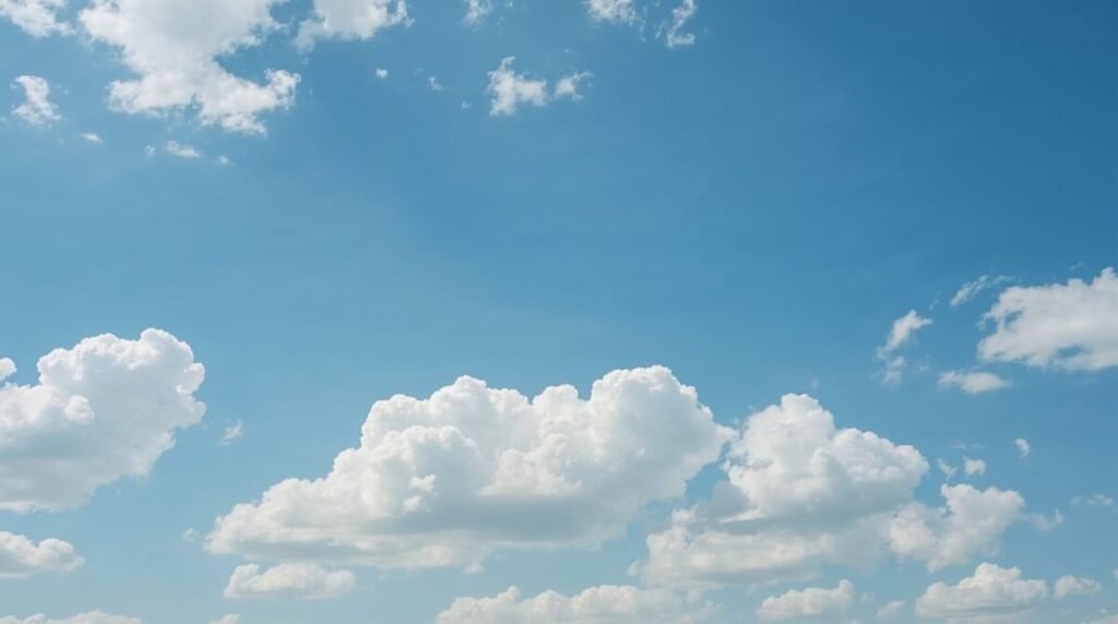 Minimalist blue sky with puffy, fluffy white clouds